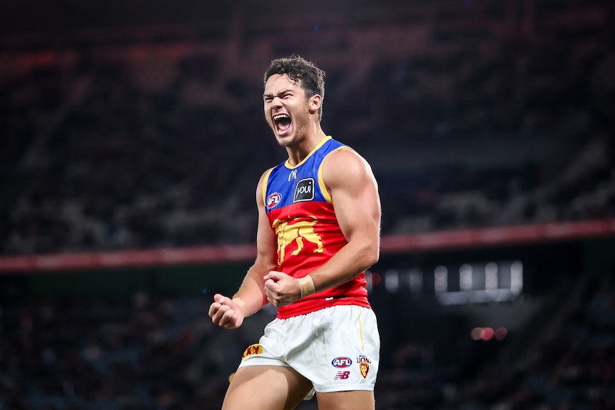 Cam Rayner pumps his fists and yells in delight