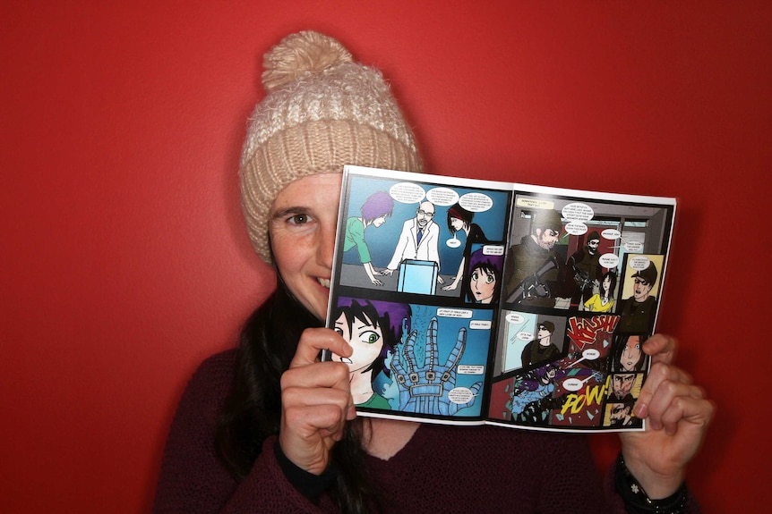 Young woman holding up comic book