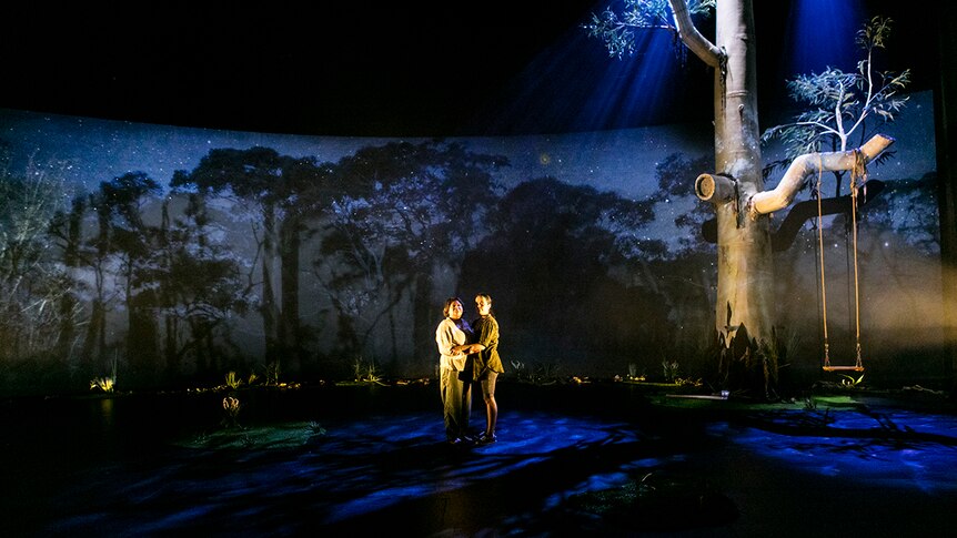 Colour photography of Ursula Yovich and Caleena Sansbury centrestage during theatre production Man with the Iron Neck.