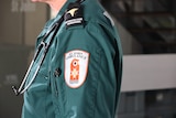 The torso of a person in a paramedic uniform from the side. 