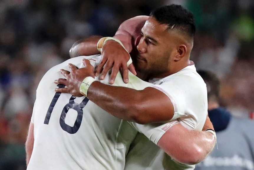 English players hug after losing the Rugby World Cup final to South Africa.