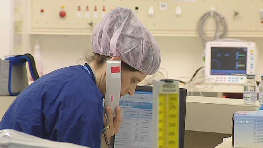 Theatre nurse at a hospital work station