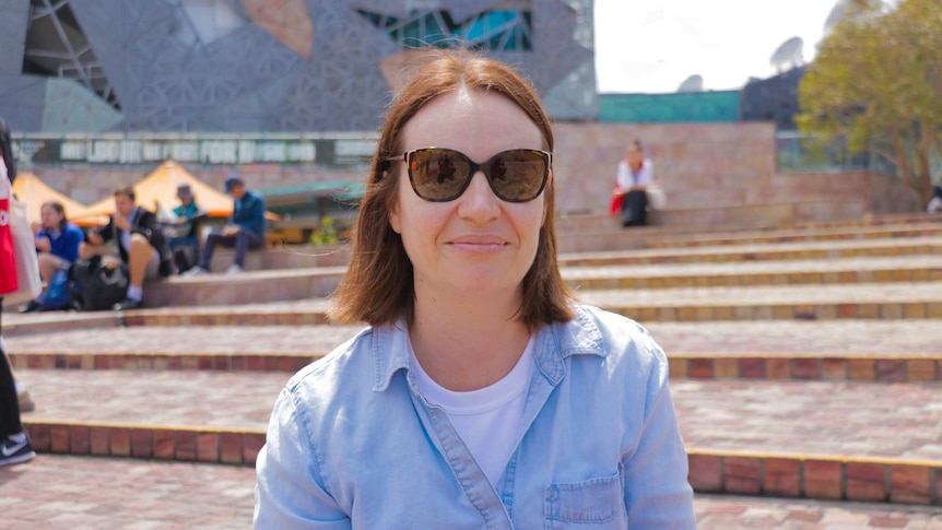 A portrait of Renae sitting down in Melbourne's Federation Square for a story on racism.