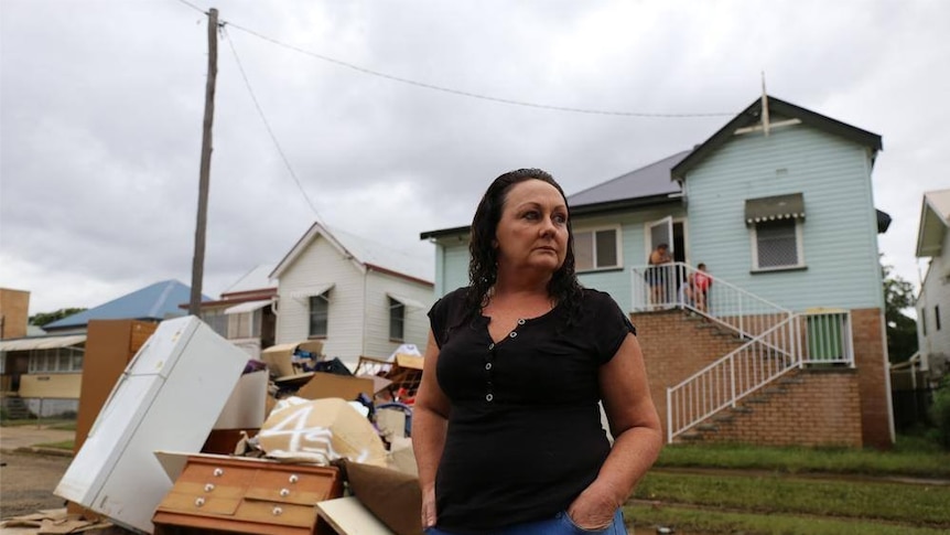 Joanne Hourigan from Casino Street South Lismore surveys the damage on her street on April 2