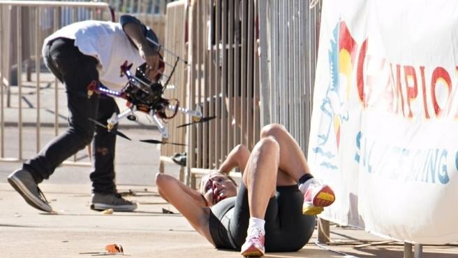 Triathlete Raija Ogden lays on the ground after being hit by a drone.