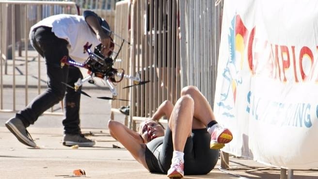 Raija Ogden lays on the ground after being hit by a drone.