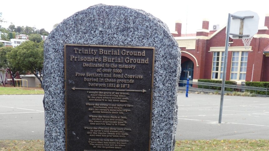 A stone plaque dedicated to the more than 500 settlers and bond convicts buried beneath Campbell Street Primary.