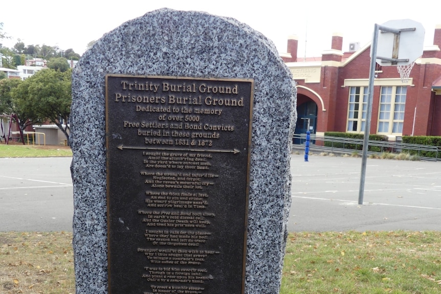 A stone plaque dedicated to the more than 5000 settlers and bond convicts buried beneath Campbell Street Primary.