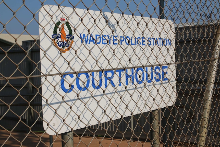 A sign at the entrance of the police station and makeshift courthouse