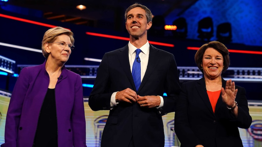 US Senator Elizabeth Warren, Beto O'Rourke and Senator Amy Klobuchar pose before the start of a deabte.