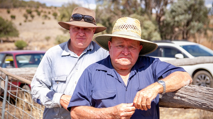 Father and son farmers, Steve and Des Kajewski lean on a fence on their farm near Kulpi in September 2019.
