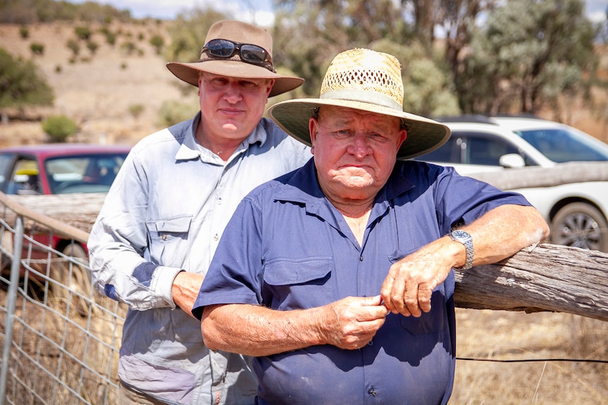 Father and son farmers, Steve and Des Kajewski lean on a fence on their farm near Kulpi in September 2019.