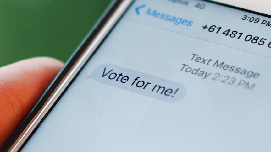 A phone containing a message saying 'vote for me'.