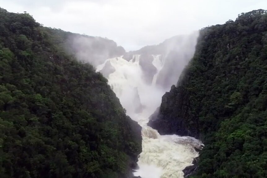 Water rushes over falls after heavy rain