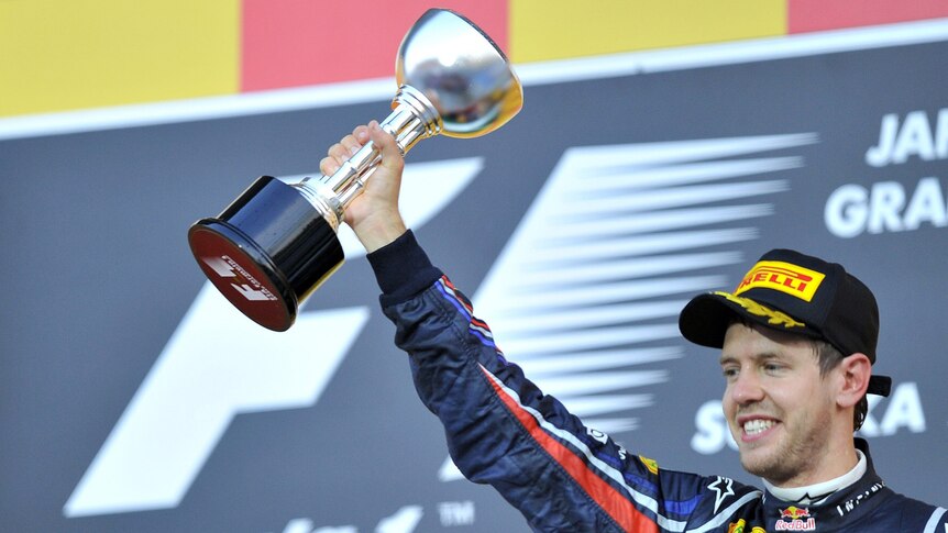 Sebastian Vettel with trophy on Japan podium after winning 2011 F1 championship