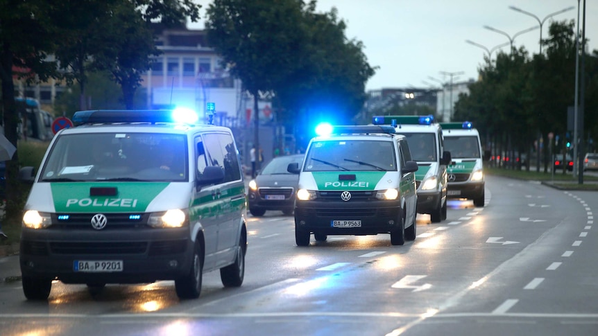 police cars travel along the road