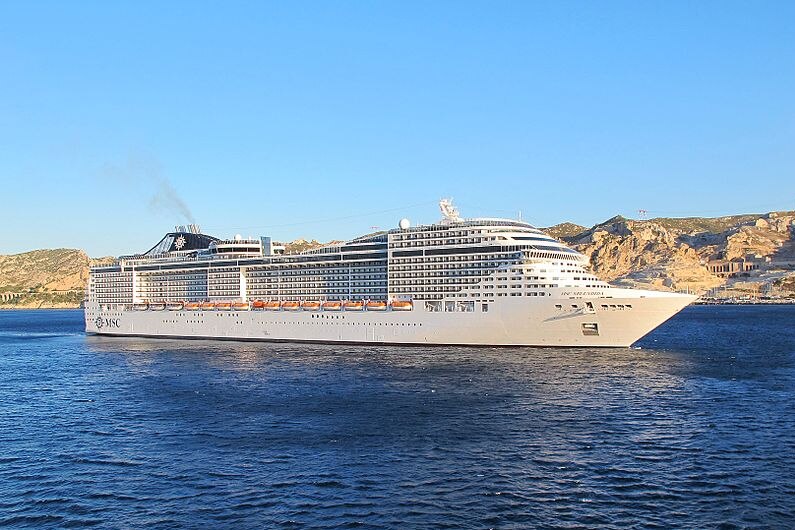 The cruise ship MSC Splendida on the water with the hills and rugged coastline of Marseille visible in the background.
