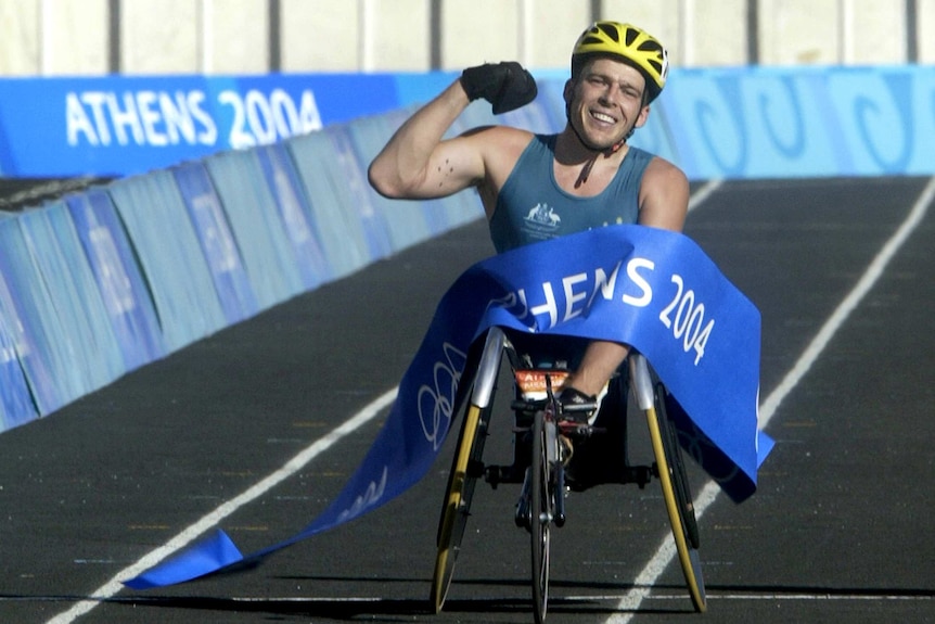 Australian Kurt Fearnley crosses finish line to win men's T54 marathon at the Athens Paralympics.