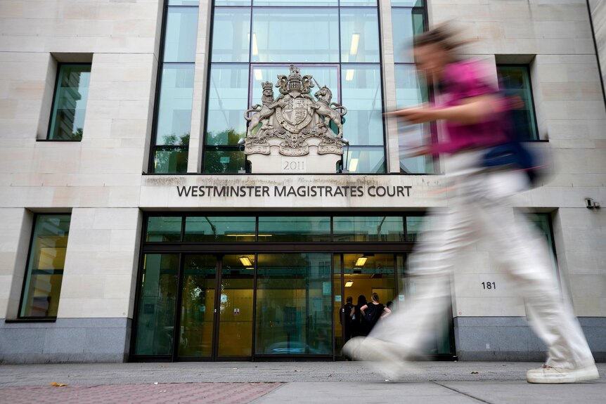 Woman walks past entrance to London's Westminster Magistrates Court.