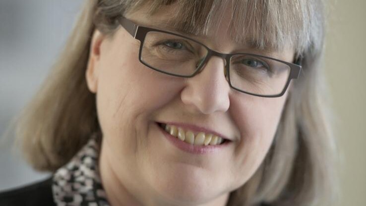A portrait photograph of Associate Professor Donna Strickland, smiling at the camera