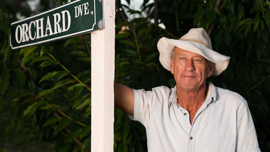 Paul Savins standing with orchard street sign