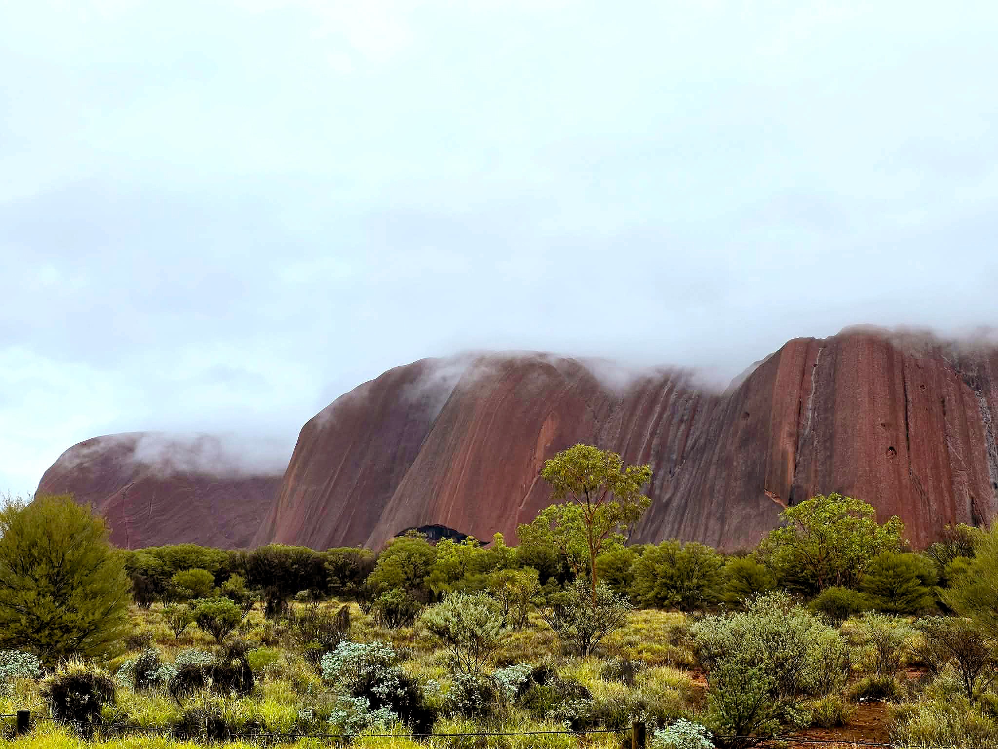 Rain streams down Uluru as large parts of NT soaked by wet weather