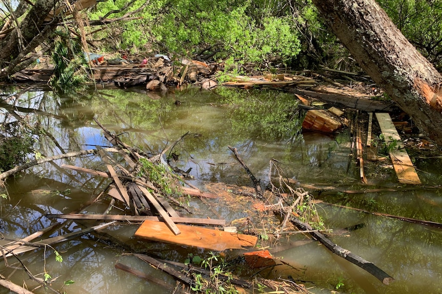 Broken timbers and other debris in floodwater