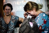 Woman cries in makeshift bomb shelter in Ukraine