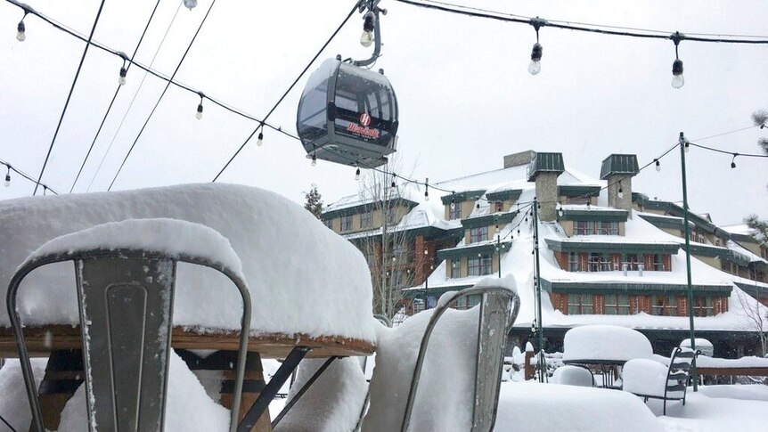 Fresh snow covers most of a table and chairs at the Heavenly Mountain Resort in South Lake Tahoe, California.