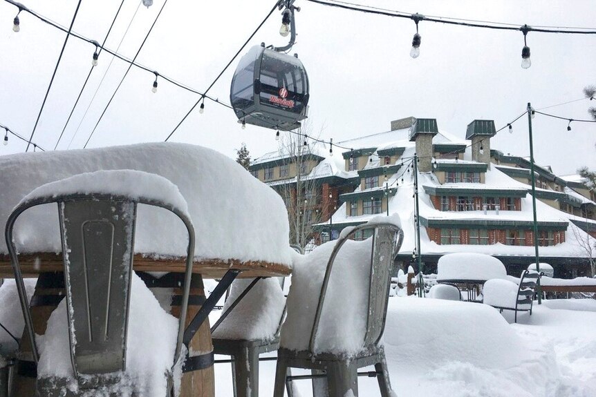 Fresh snow covers most of a table and chairs at the Heavenly Mountain Resort in South Lake Tahoe, California.