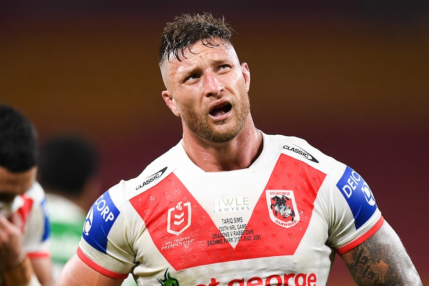 Tariq Sims holds his hands on his hips and looks up