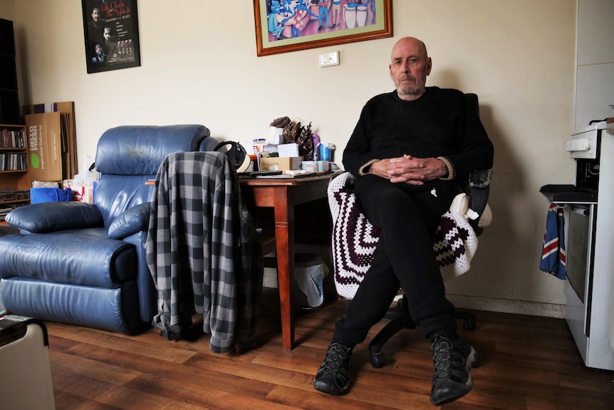 Man sits in a chair in his cabin