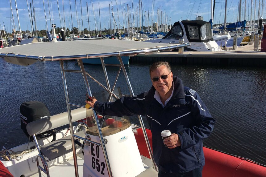 Stuart Walton from Royal Perth Yacht Club stands in his boat