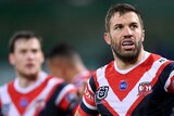 Sydney Roosters fullback James Tedesco looks tired with his hand son his hips during an NRL game. Teammate Luke Keary is nearby.