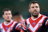 Sydney Roosters fullback James Tedesco looks tired with his hand son his hips during an NRL game. Teammate Luke Keary is nearby.