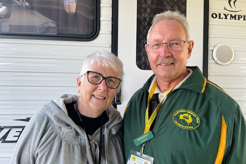 senior couple in front of their van 