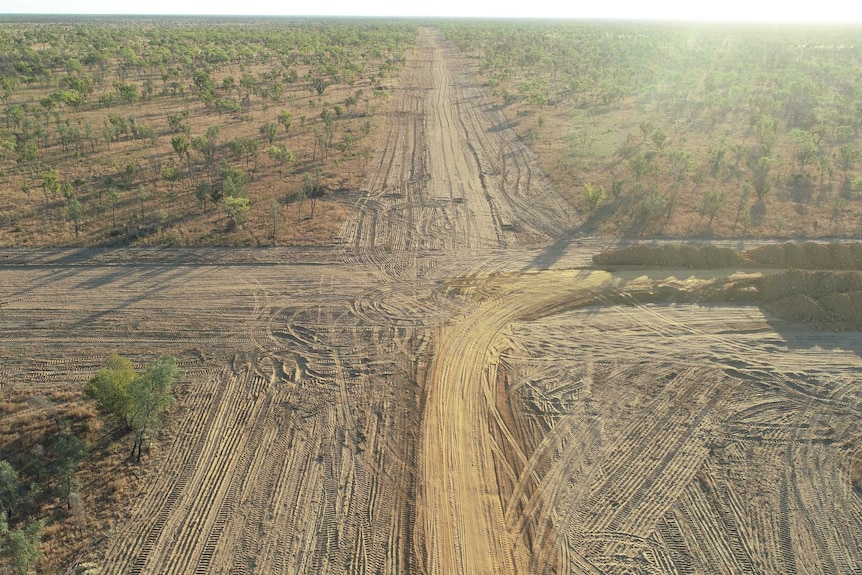 An aerial view of large cross-roads cleared through bush