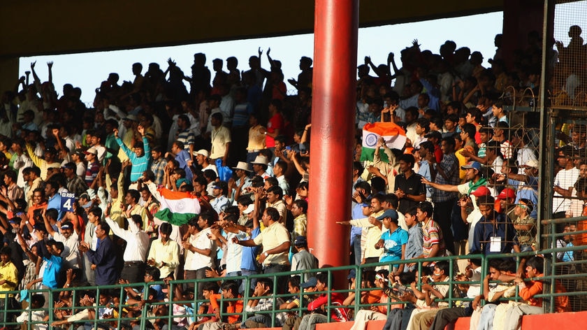 Cricket mad: The explosions didn't stop fans swarming to the Chinnaswamy stadium.