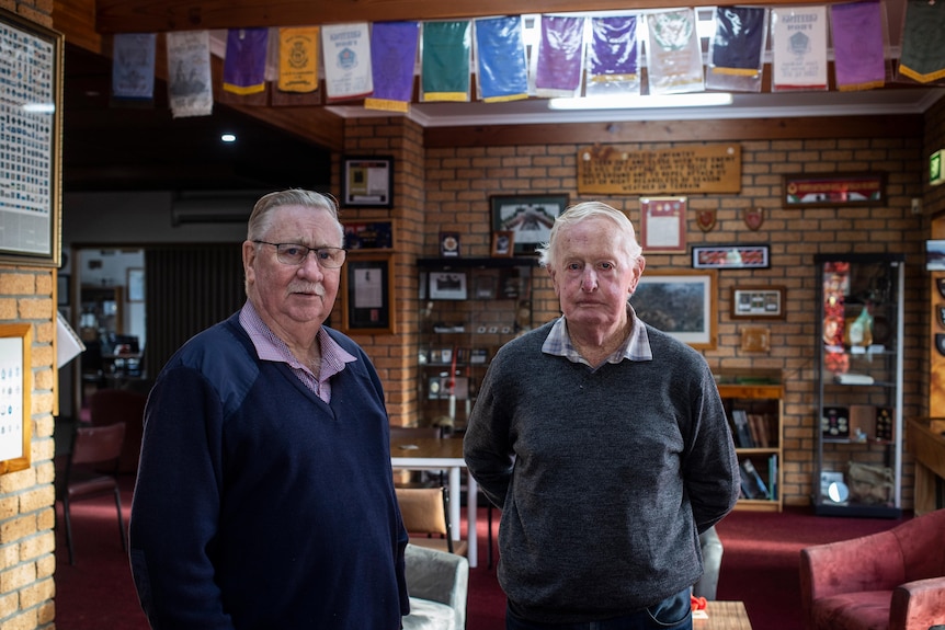 Two older men standing in a RSL club 