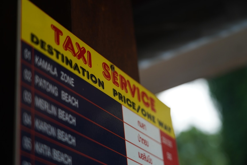 A Taxi Service sign displays a price list next to destinations.