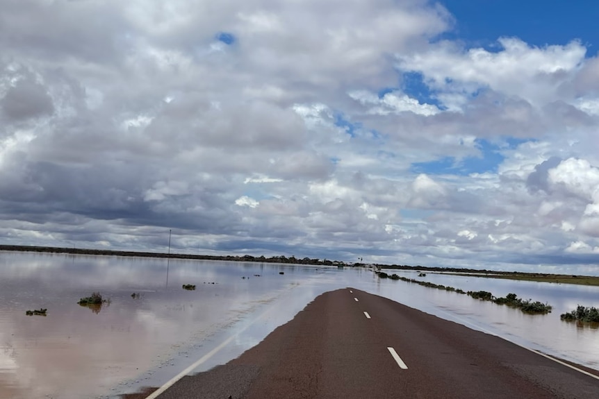An outback highway covered in flood waters