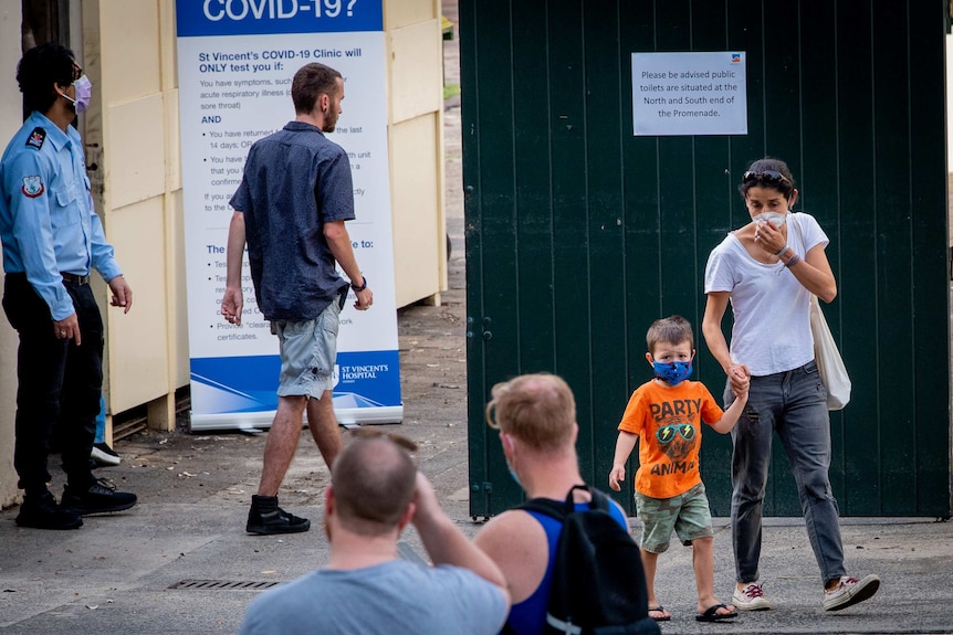 People enter and exit a COVID-19 testing clinic in Bondi, Sydney.