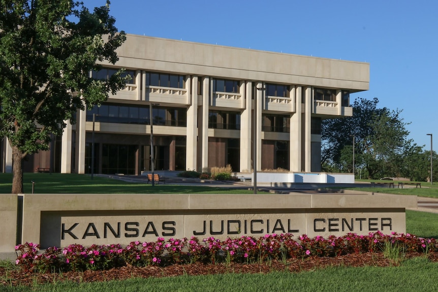 A photo of a Kansas court building with the title Kansas Judicial Center visible 