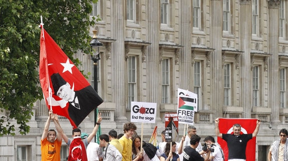 Pro-Palestinian demonstrators stand on a bus outside the British prime minister's residence
