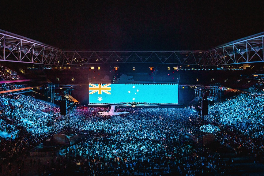 The Australian flag emblazoned on a giant screen in front of a stadium full of 50,000 people for the U2 concert