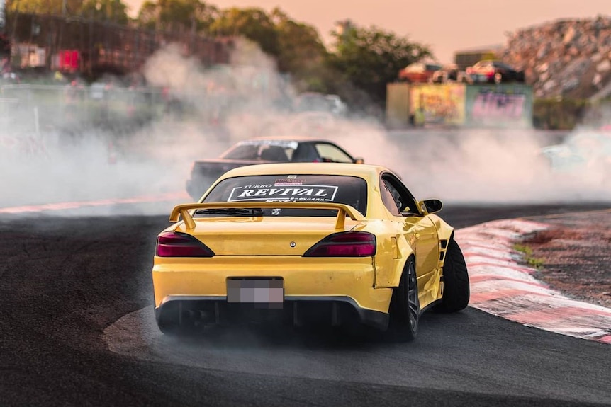 Cars race at a drifting event at Archerfield Drift Park on Brisbane's southside.