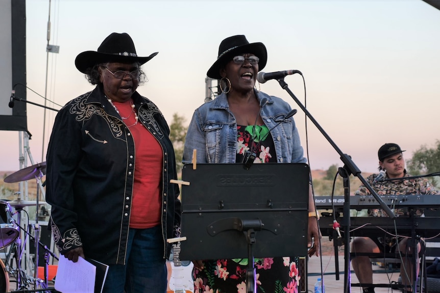 Two women singing. 