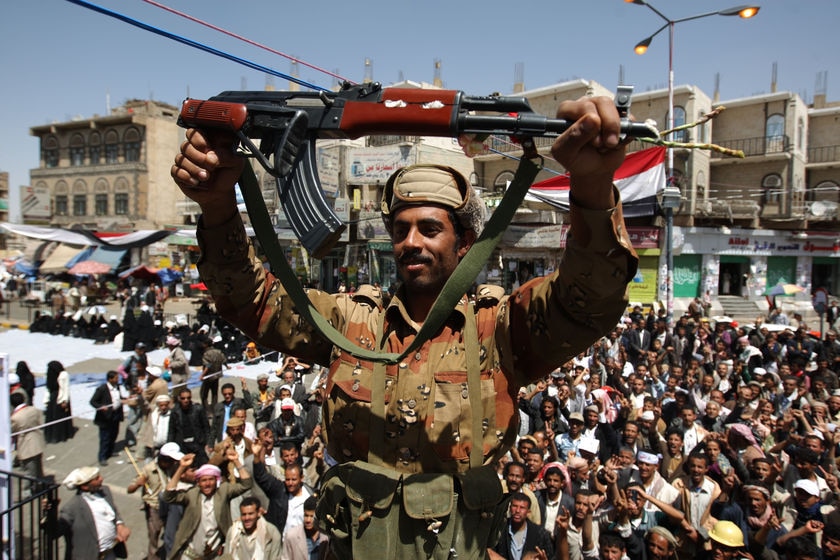 A defected Yemeni soldier holds up his weapon as he joins anti-government protestors March 21, 2011 (AFP)