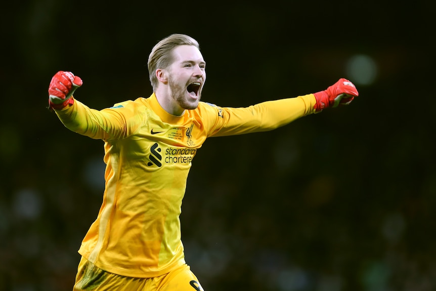 Liverpool goalkeeper Caoimhin Kelleher celebrates scoring a penalty during the Carabao Cup by raising his fists