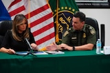 Melania Trump looks at photos while Chief Patrol Agent Rodolfo Karisch talks